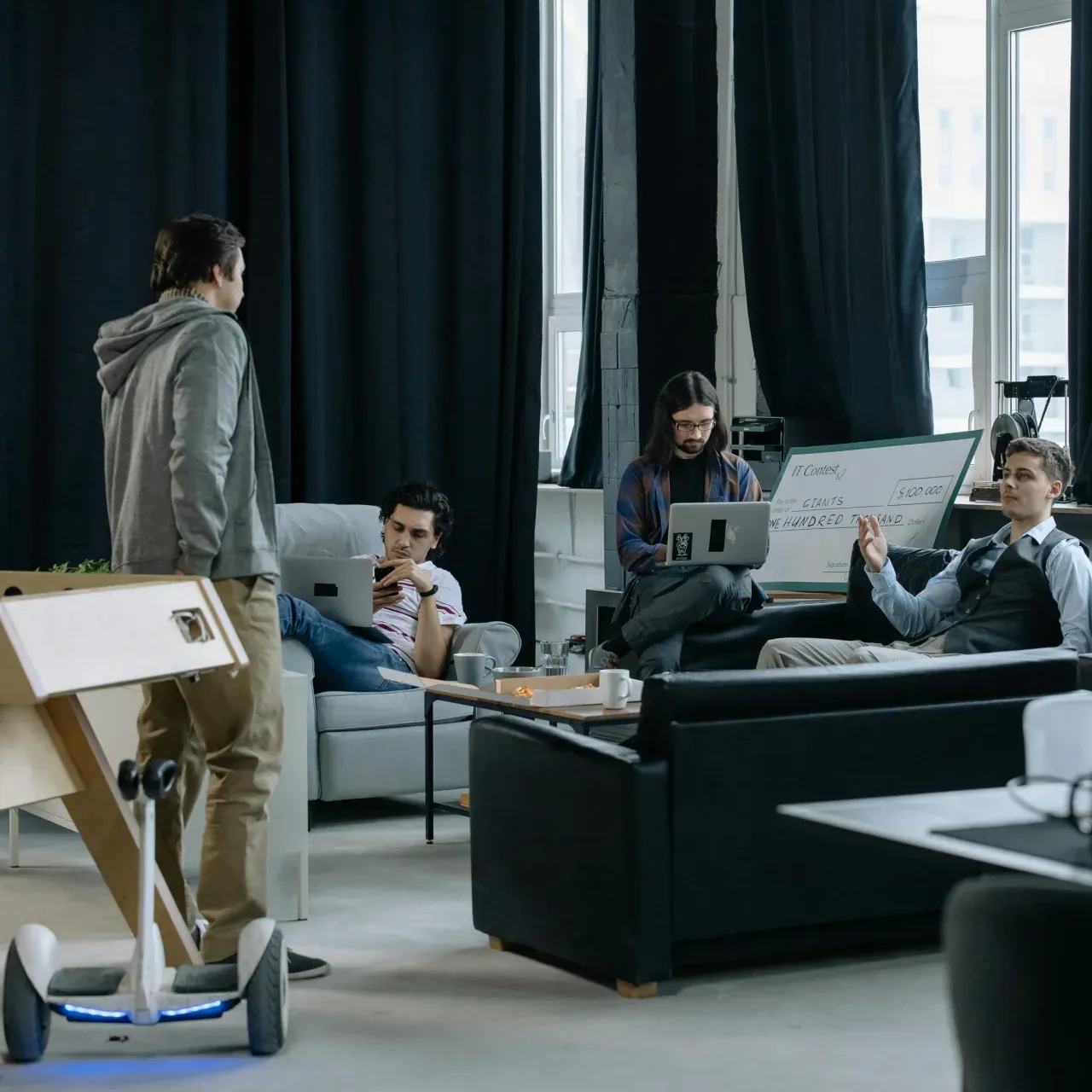Startup headquarters with workstations and soft seating